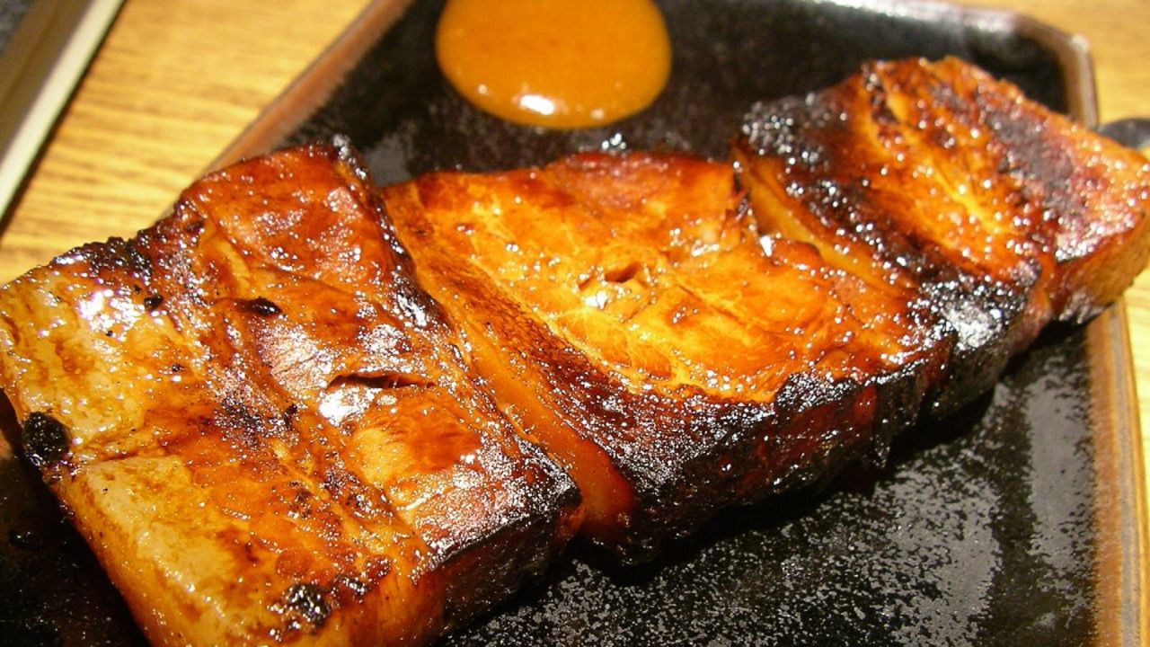 <strong>Glazed pork:</strong> Rafute are succulent slabs of pork belly simmered in soy sauce and glazed with brown sugar. It is sweet and savory, usually eaten on its own, or as a topping for Okinawa soba.