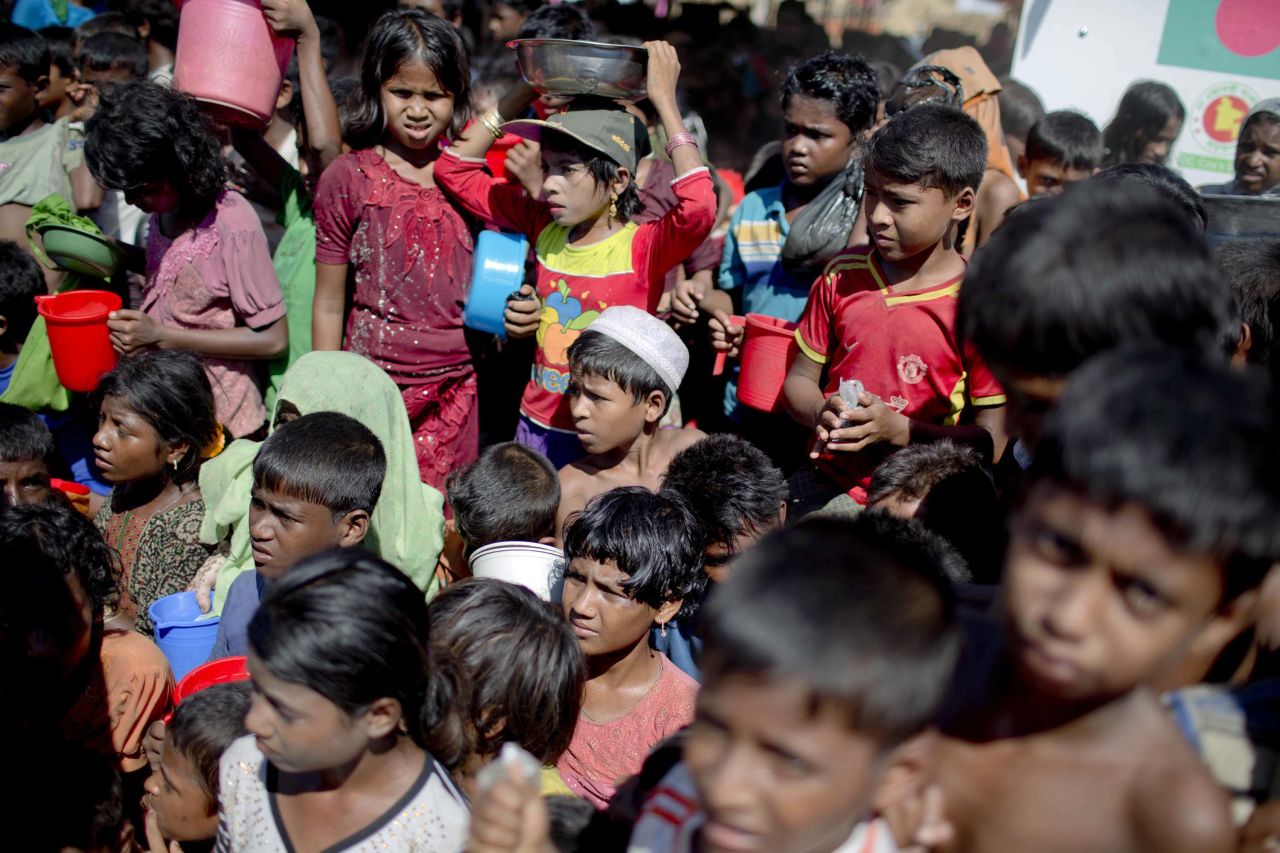 Rohingya children wait to receive food from an aid group at a refugee camp in Ukhiya, Bangladesh, on Tuesday, November 14. More than 600,000 of the Rohingya Muslim minority group from Myanmar's Rakhine state have fled to Bangladesh, according to the United Nations.