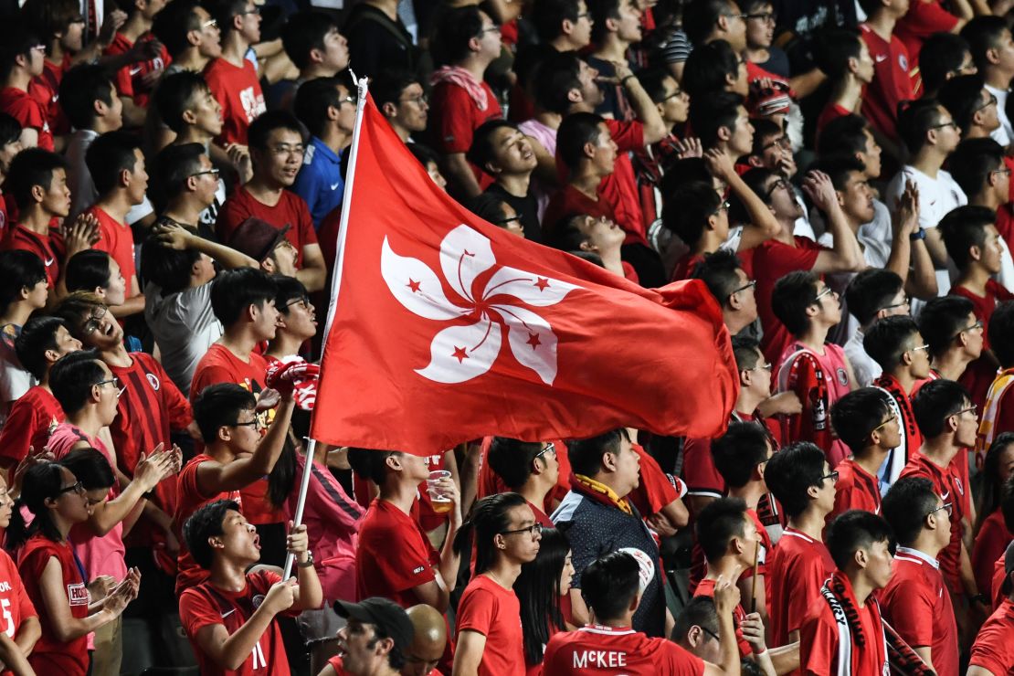 Local football fans hold up the Hong Kong flag during a match against Malaysia in Hong Kong on October 10, 2017.