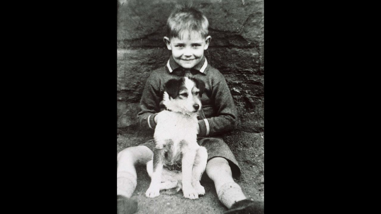 A young Connery poses with a dog. He was born into a working-class family in Edinburgh.
