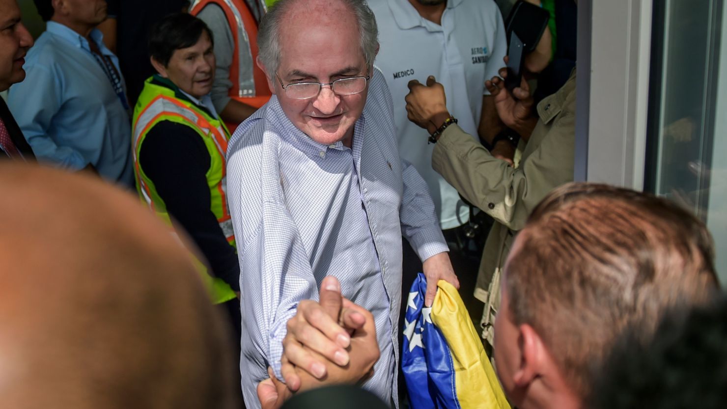 The mayor of Caracas, Antonio Ledezma, 62, greets followers Friday at El Dorado International Airport in Bogota, Colombia, before embarking to Spain after escaping house arrest in the Venezuelan capital. 