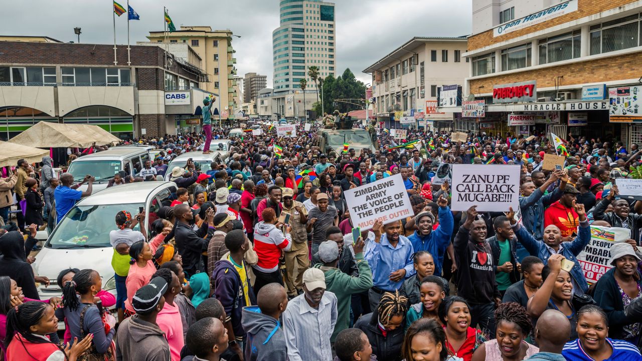 People march through a street in Harare on Saturday.