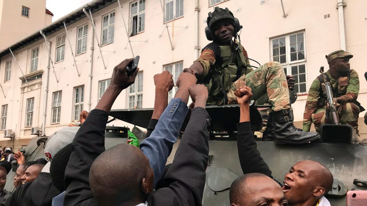A soldier greets protesters in Harare on Saturday.