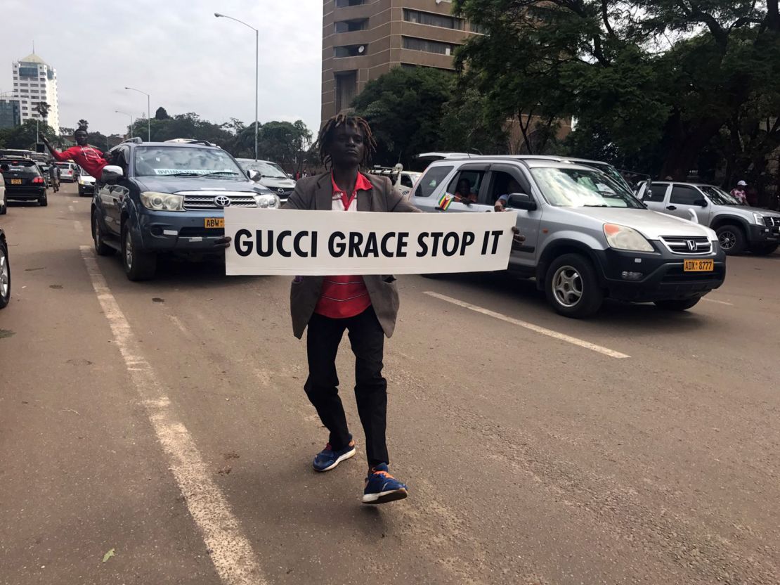 A demonstrator carries a sign directed at first lady Grace Mugabe.