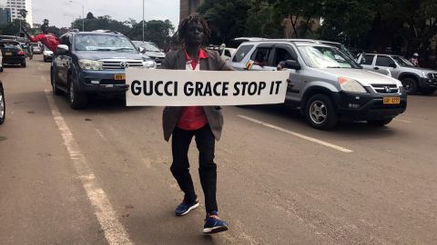 A demonstrator carries a sign directed at first lady Grace Mugabe.