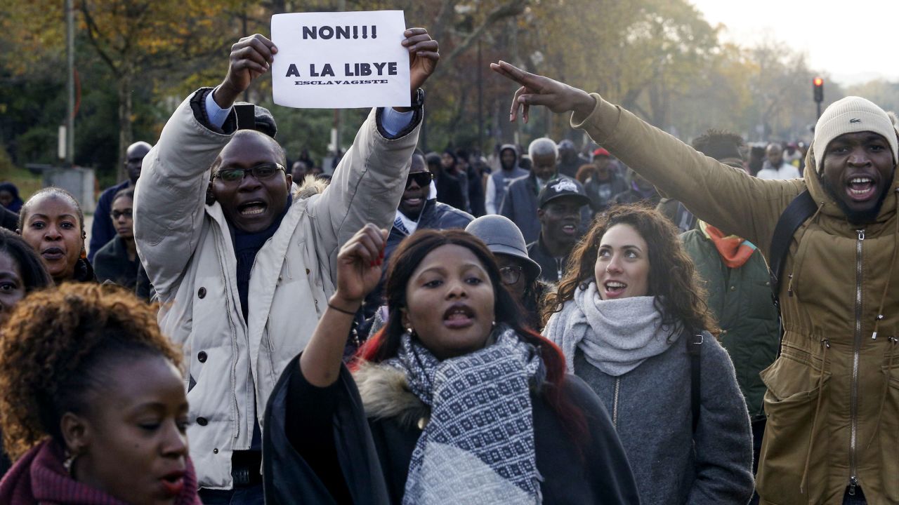 A man holds a placard reading "No to slavery in Libya" during a march against "slavery in Libya" on November 18 in Paris. 