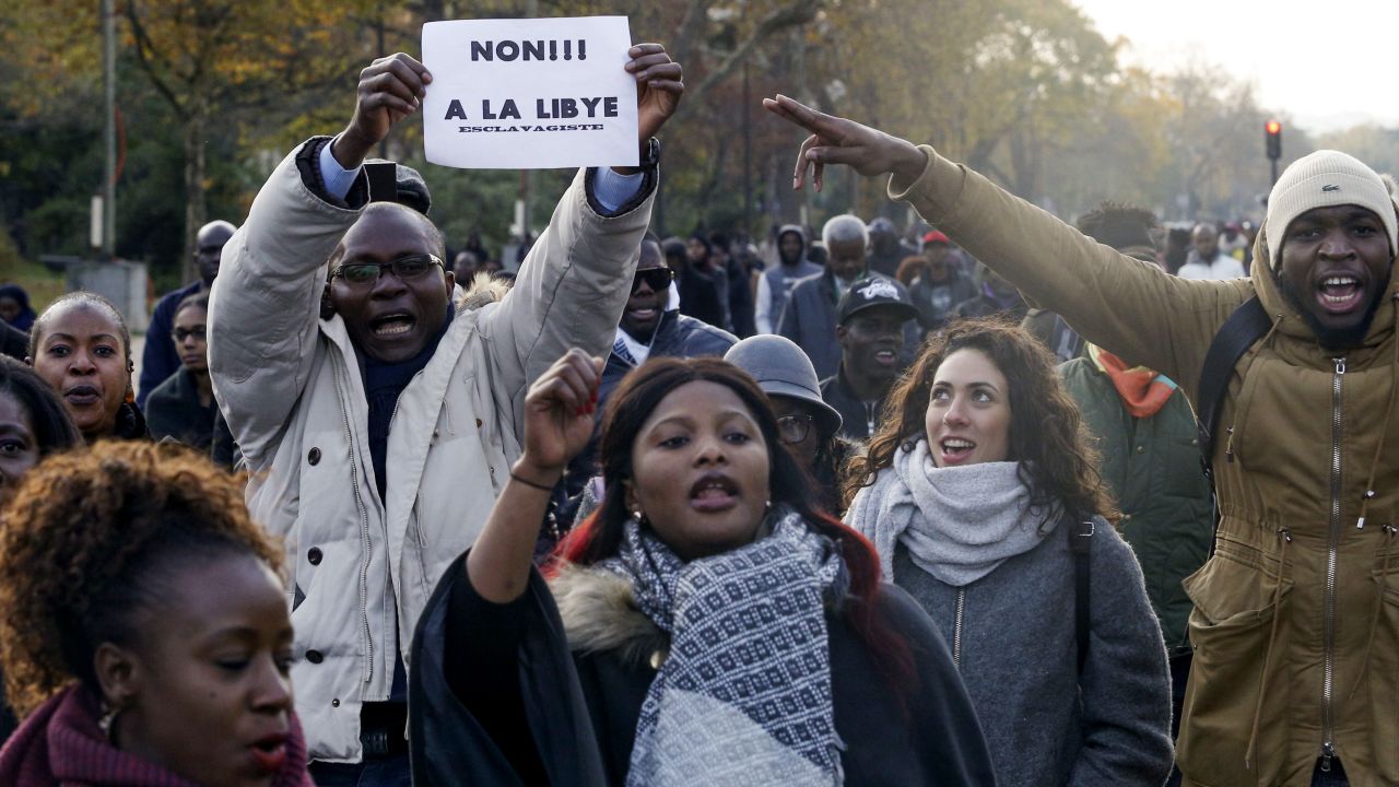 A man holds a placard reading "No to slavery in Libya" during Saturday's march.