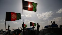 Afghan security forces wave their banner in August in honor of the Muslim holiday Eid.
