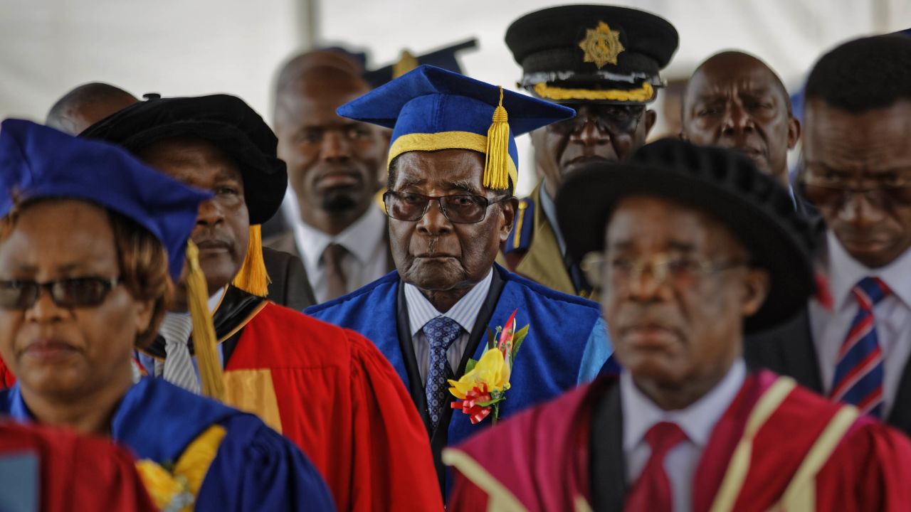 Mugabe, center, presides over a student graduation ceremony at Zimbabwe Open University on Friday.