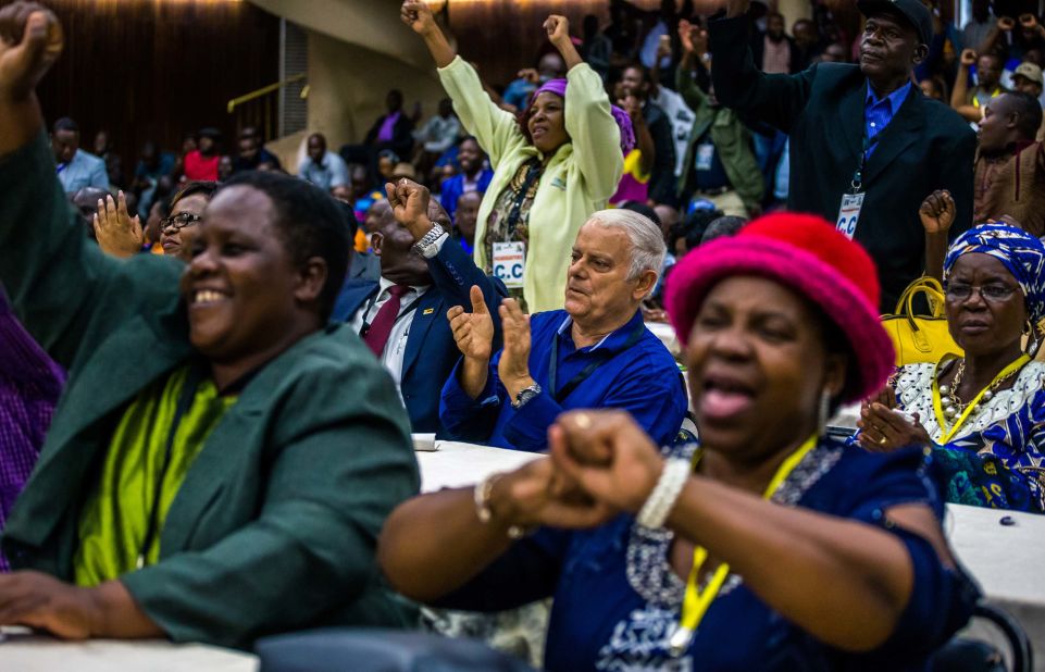 Members of the ruling party ZANU-PF react after the decision to oust Mugabe as party leader on November 19.