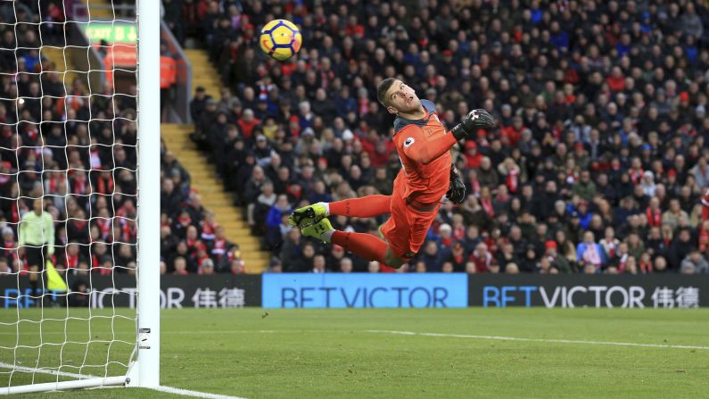 Southampton goalkeeper Fraser Forster watches the ball go into his net during a Premier League match in Liverpool, England, on Saturday, November 18. Liverpool defeated Southampton 3-0.