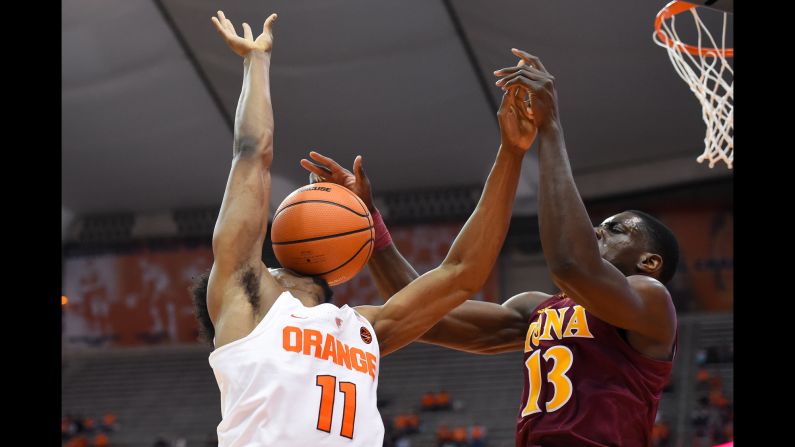 Iona's TK Edogi blocks a shot onto Oshae Brissett's face during a college basketball game at Syracuse on Tuesday, November 14.