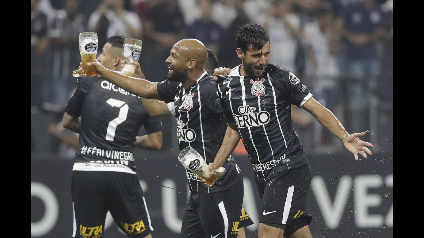 Soccer players from the Brazilian club Corinthians carry drinks as they celebrate clinching the league title in Sao Paulo, Brazil, on Wednesday, November 15.