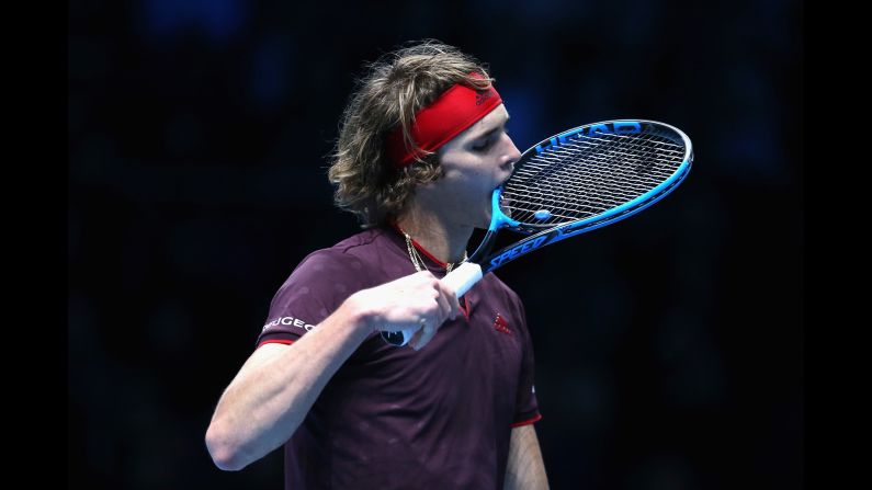 Alexander Zverev bites his racket in frustration during a match against Roger Federer on Tuesday, November 14. Federer won their group-stage match at the ATP World Tour Finals.