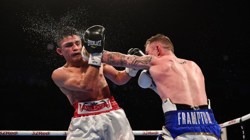 Carl Frampton punches Horacio Garcia during their featherweight bout in Belfast, Northern Ireland, on Saturday, November 18. Frampton won by unanimous decision.