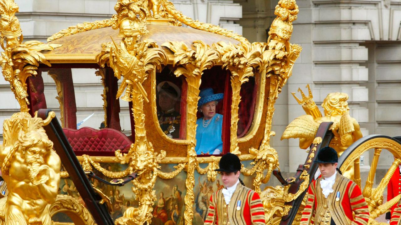 The gilded eight horse-drawn State Coach is on display in the Royal Mews.