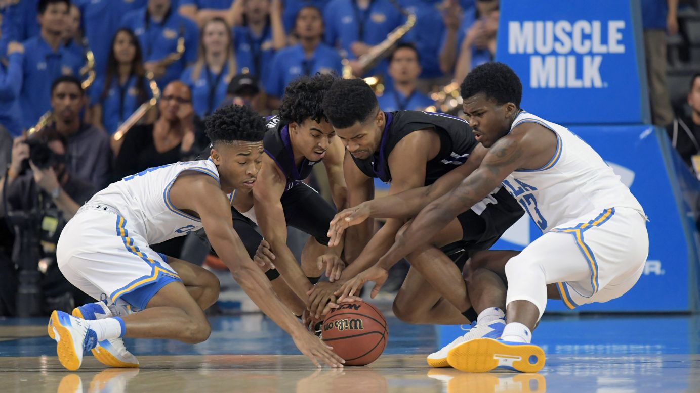 Players from UCLA and Central Arkansas battle for a loose ball during a college basketball game in Los Angeles on Wednesday, November 15.