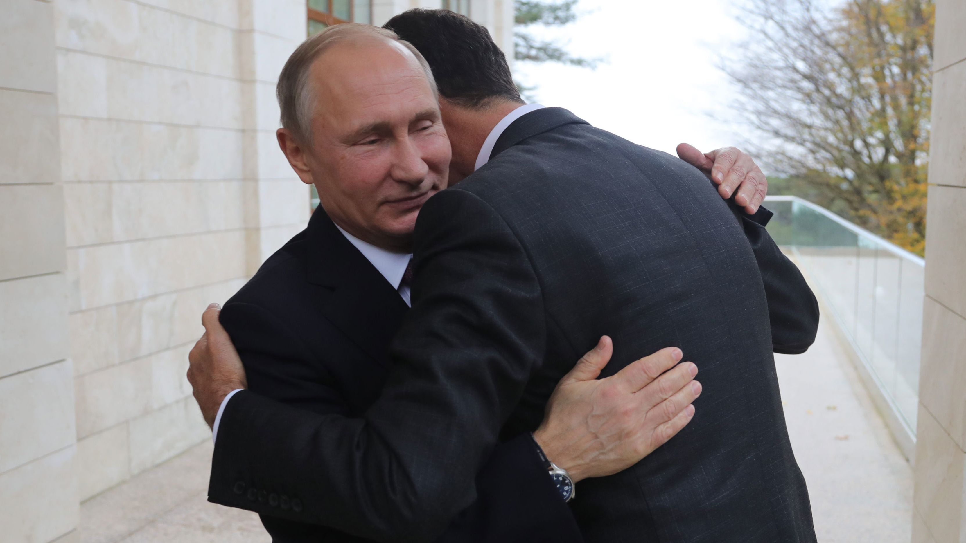 Putin (L) embraces Assad during their meeting in Sochi last month.  