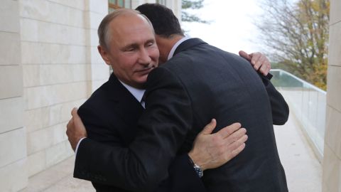 Vladimir Putin embraces Bashar al-Assad during a meeting in Sochi, Russia, on Monday.