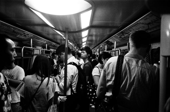<strong>Trainspotting:</strong> "This man caught me photographing him while on the MTR [subway train]. Traveling on the train is a good way to capture people in their own world or deepest thought."