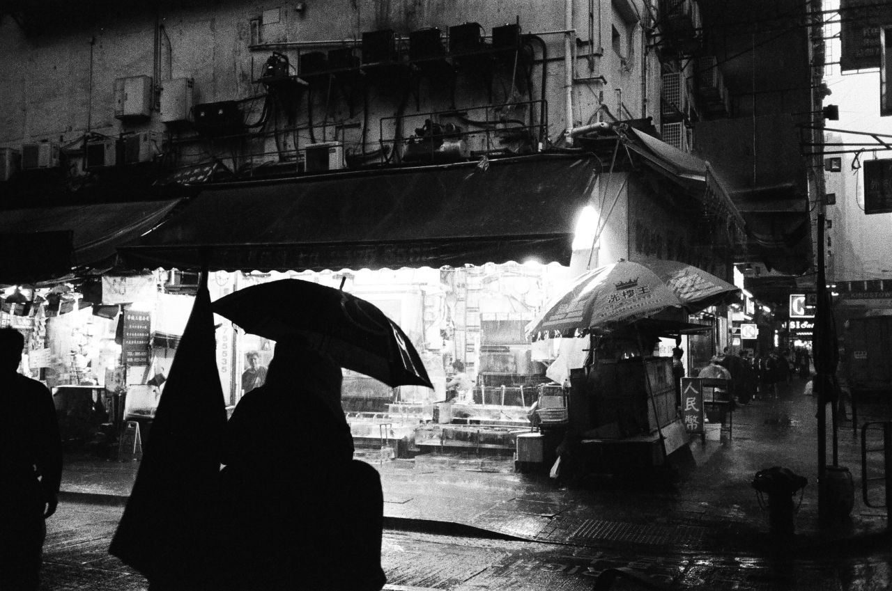 <strong>When It Rains:</strong> "Sometimes an accidental shot is the best shot. I planned to take a photo of a corner fish market in Causeway Bay when it started to rain. A person walked into my shot with their umbrella opened, creating this silhouette."