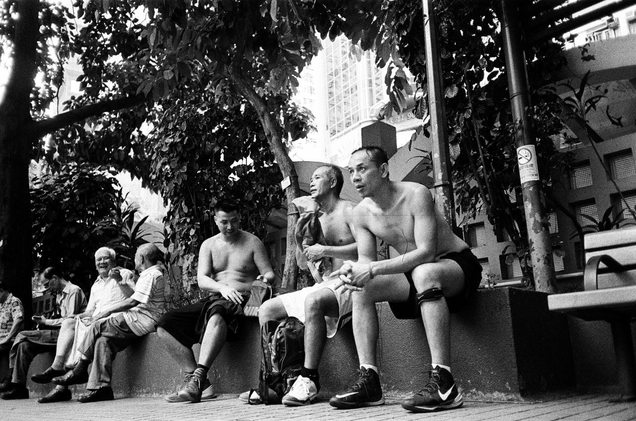 <strong>Wild Ball:</strong> "I captured these men taking a break after playing a game of street ball. Basketball is a loved sport in Hong Kong, where there's at least one court in every neighborhood. Southorn Playground in Wan Chai is a popular spot with Sundays being the busiest."