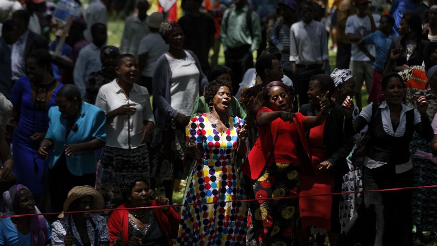 Zimbabweans gather to pray for the country in a park opposite the parliament building in downtown Harare, Zimbabwe Tuesday, Nov. 21, 2017. Zimbabwean President Robert Mugabe should acknowledge the nation's "insatiable desire" for a leadership change and resign immediately, the recently fired vice president and likely successor to the 93-year-old leader said Tuesday. (AP Photo/Ben Curtis)