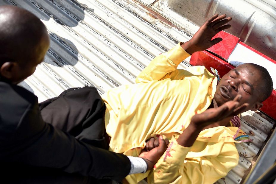 A man accused of supporting Mugabe is attacked outside Parliament on November 21.