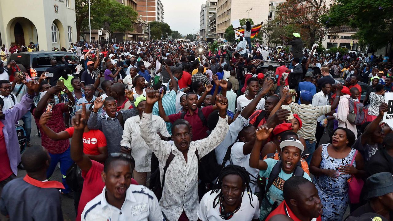 People celebrate in the streets of Harare, after the resignation of Zimbabwe's president Robert Mugabe on November 21, 2017.
The bombshell announcement sparks scenes of wild celebration in the streets of Harare, with car horns honking and crowds dancing and cheering over the departure of the autocrat who has ruled Zimbabwe since independence.  / AFP PHOTO / Tony KARUMBA        (Photo credit should read TONY KARUMBA/AFP/Getty Images)