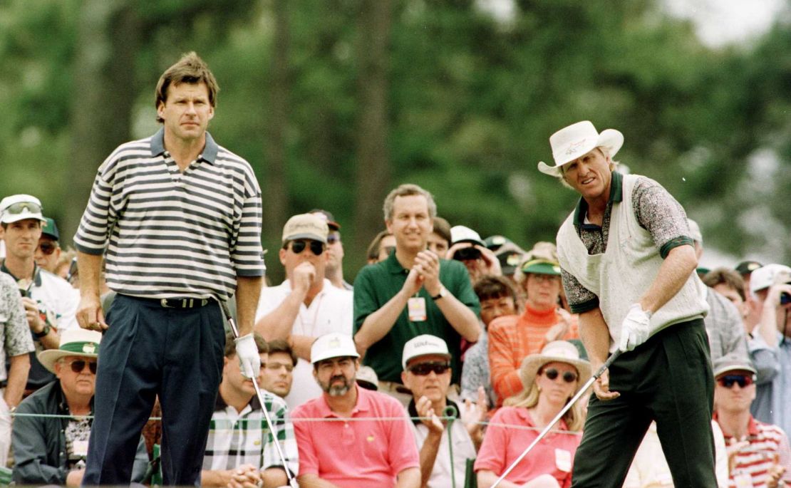Faldo (left) watches playing partner Greg Norman tee off on the first hole during third round of play in the Masters.