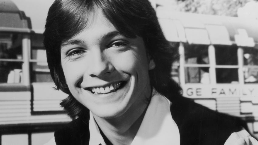 1970:  Headshot portrait of American pop musician and actor David Cassidy smiling and holding a guitar.  (Photo by Hulton Archive/Getty Images)