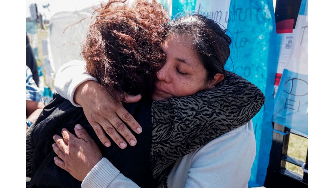 Elena Alfaro, right, sister of missing submariner Cristian Ibáñez, is comforted by a woman outside Argentina's navy base in Mar del Plata.