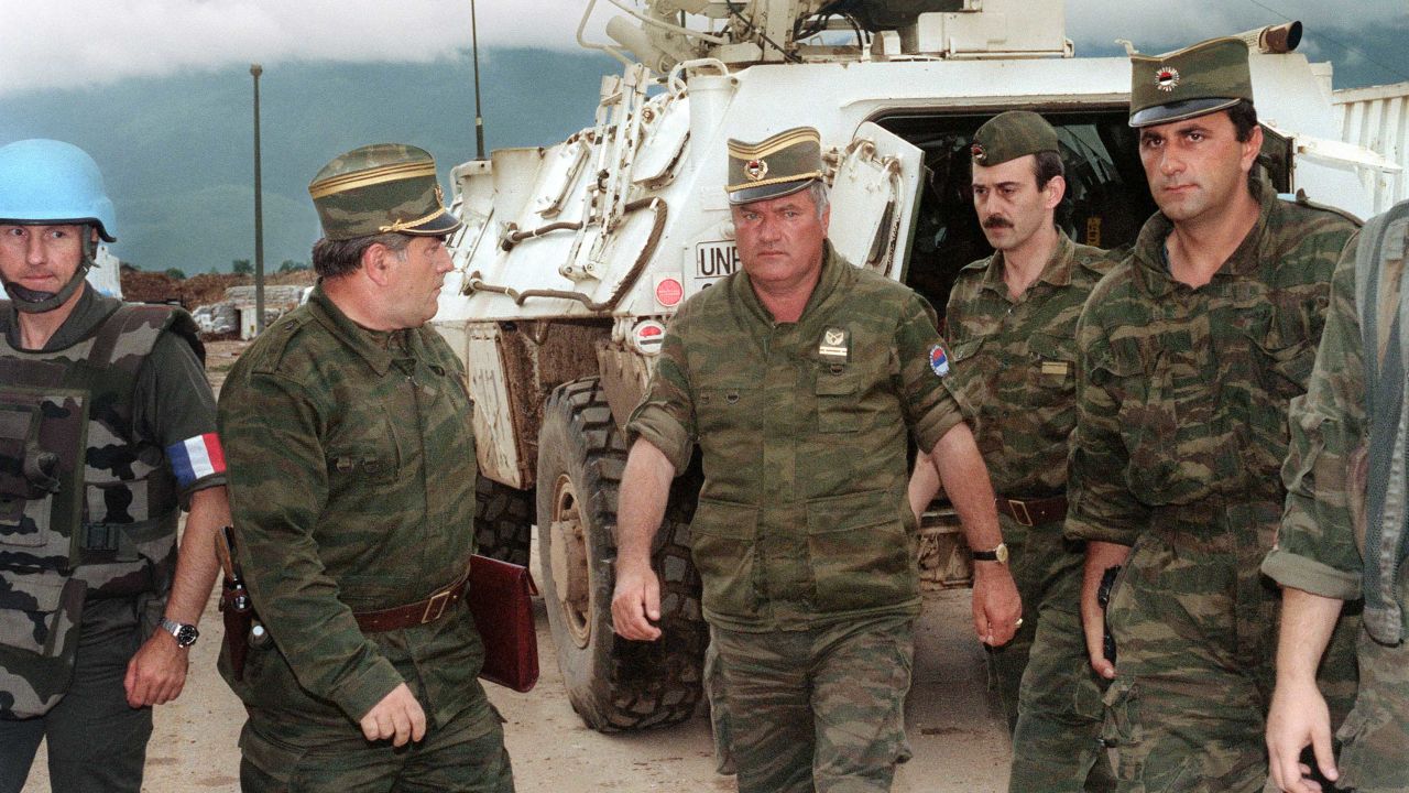 Commander of Serbian forces in Bosnia General Ratko Mladic (C) arrives at the airport of Sarajevo on August 10, 1993 in order to negociate the withdrawal of his troops from Mount Igman. The Bosnian-Hercegovina peace talks session in Geneva were cancelled on August 12 because Serbian forces reportedly still occupied the strategic heights. AFP PHOTO GABRIEL BOUYS (Photo credit should read GABRIEL BOUYS/AFP/Getty Images)