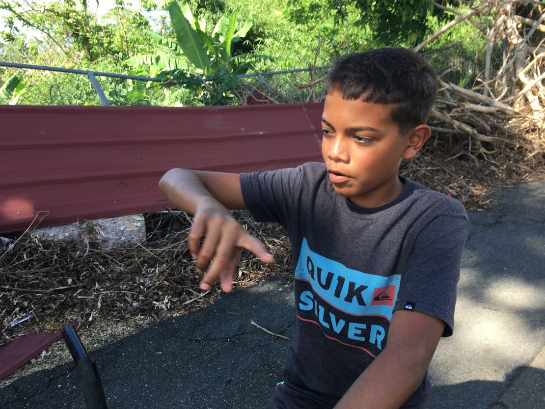 Ian Nieves, 12, outside the school where his family has lived since the storm hit. 