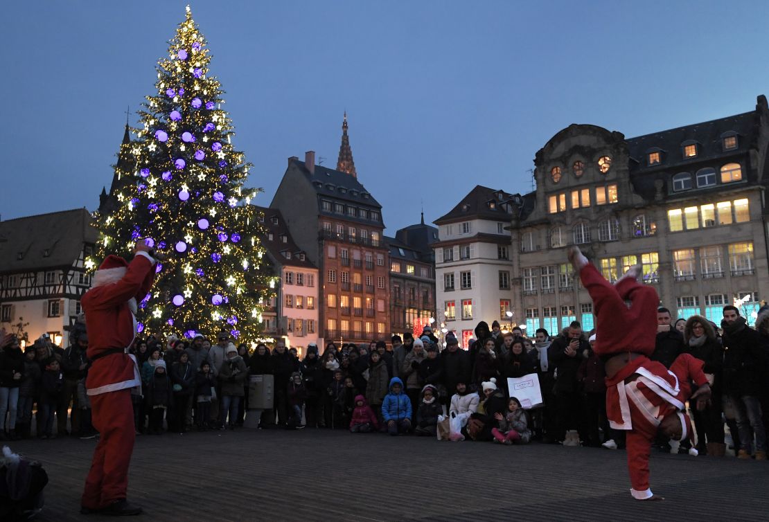 Street artists dressed as Santa Claus perform during the Christmas market in Strasbourg.