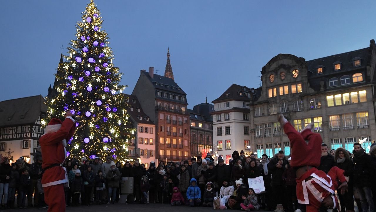Street artists dressed as Santa Claus perform during the Christmas market in Strasbourg.
