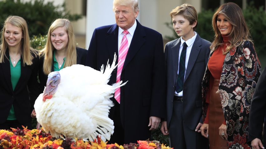 President Donald Trump, center, with first lady Melania Trump, right, and their son Barron Trump, look at Drumstick, the National Thanksgiving Turkey after being pardoned during a ceremony in the Rose Garden of the White House in Washington, Tuesday, Nov. 21, 2017. This is the 70th anniversary of the National Thanksgiving Turkey presentation. (AP Photo/Manuel Balce Ceneta)