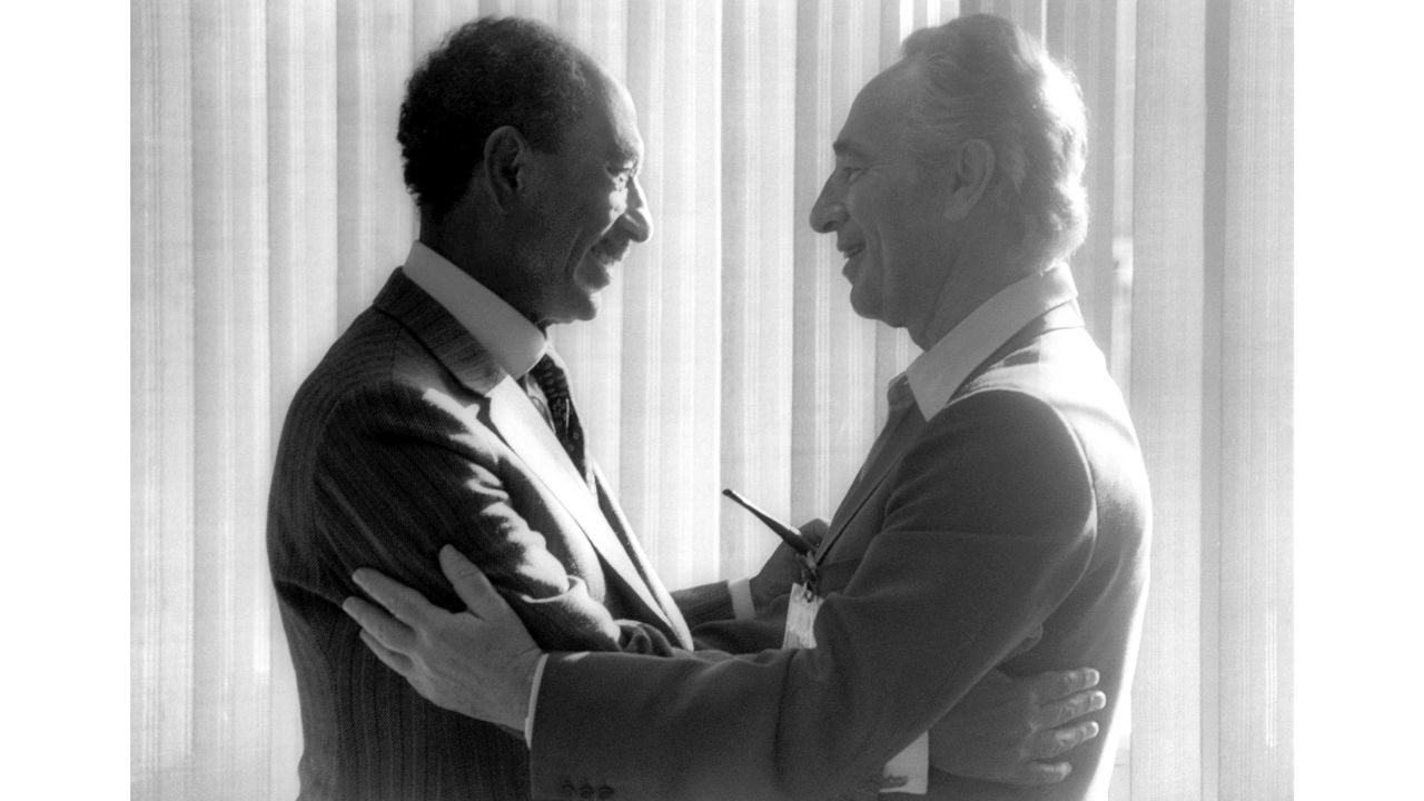 Egyptian President Anwar Sadat, left, greets then-Israeli opposition leader Shimon Peres in May 1979 in the southern Israeli city of Beersheva.