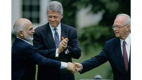 Jordan's King Hussein and Israeli Prime Minister Yitzhak Rabin shake hands, watched by US President Bill Clinton, in 1994.