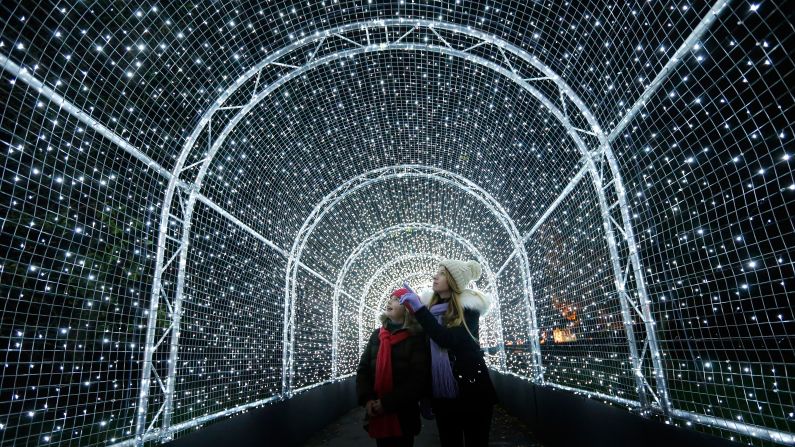 Visitors walk through a tunnel covered in Christmas lights at London's Kew Gardens on Tuesday, November 21.