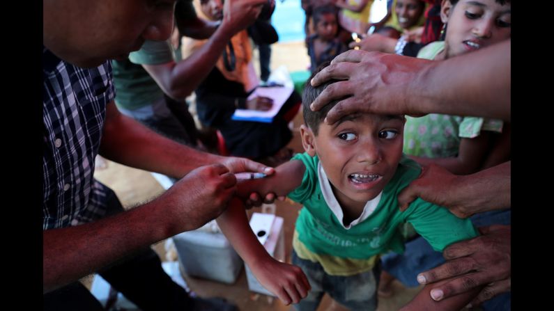 A child receives the measles vaccine at the Jamtoli refugee camp in Cox's Bazar, Bangladesh, on Saturday, November 18.