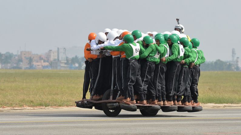 Fifty-eight members of the Tornadoes, the Indian Army's motorcycle display team, break the world record for most men on a single 50cc motorcycle on Sunday, November 19.