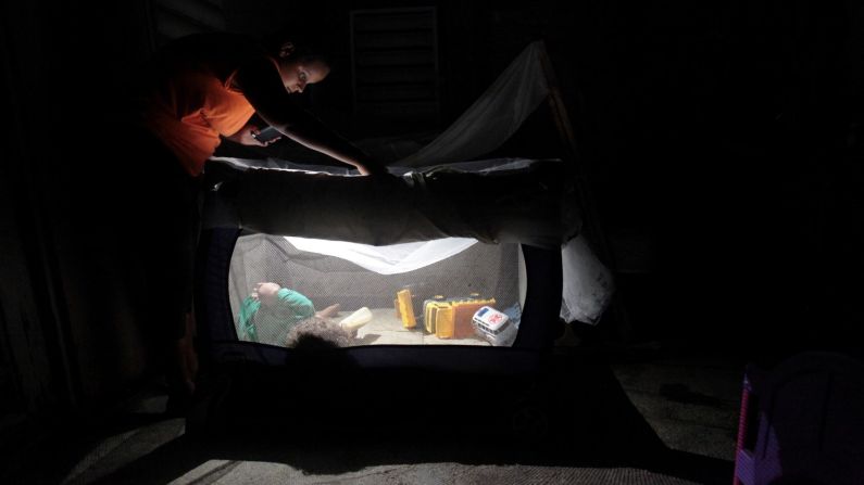 A woman in Dorado, Puerto Rico, uses a flashlight to look at her child in a crib on Friday, November 17. The territory's electrical grid was <a href="http://www.cnn.com/2017/11/23/us/puerto-rico-hurricane-maria-holidays/index.html" target="_blank">severely damaged by Hurricane Maria</a> in September. <a href="http://www.cnn.com/2017/11/16/world/gallery/week-in-photos-1116/index.html" target="_blank">See last week in 31 photos</a>