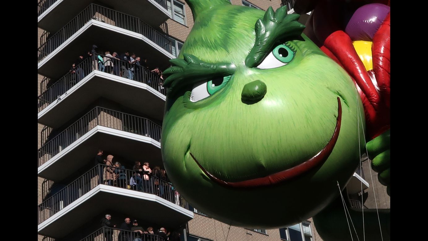 The Grinch balloon floats down Central Park West.