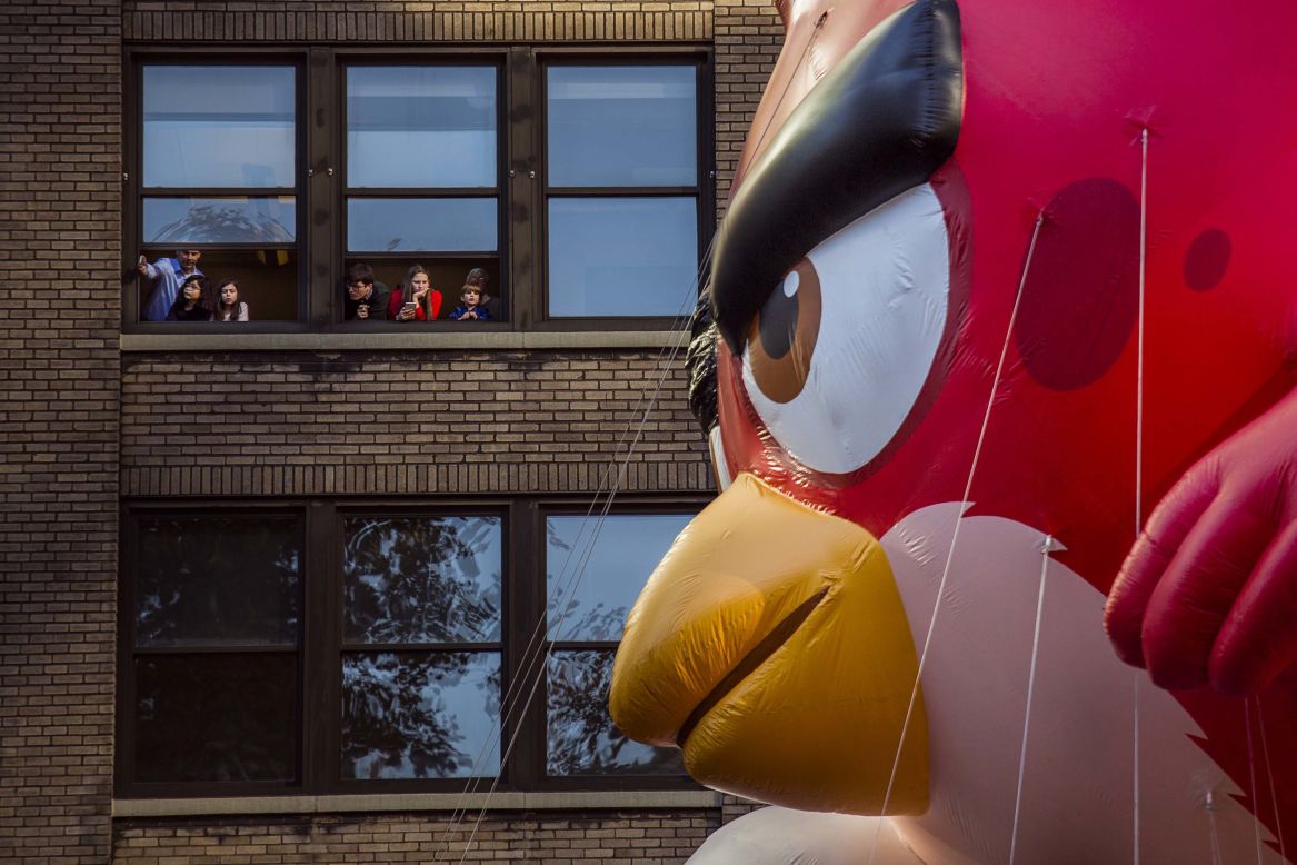 People watch an "Angry Birds" balloon on Sixth Avenue.