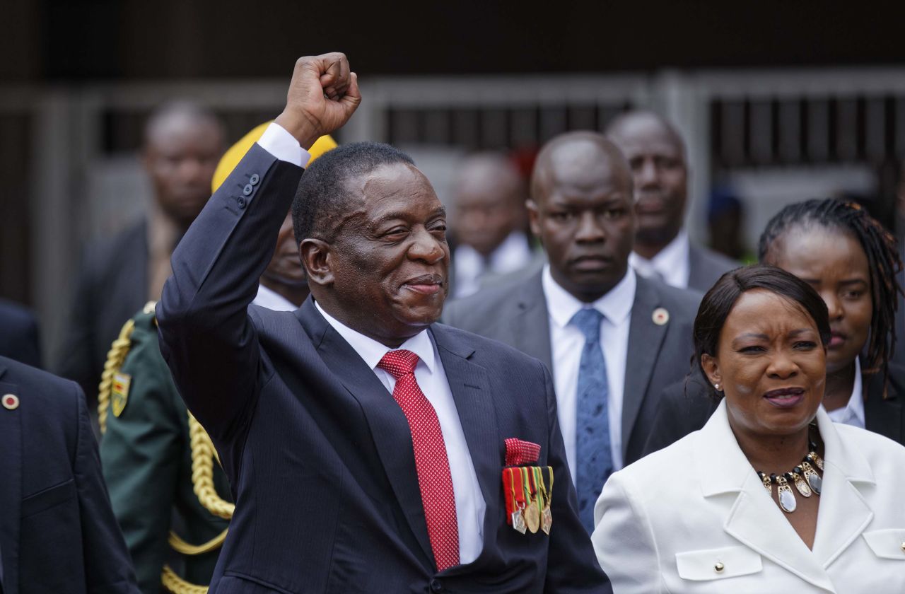 Mnangagwa greets the crowd as he arrives at the inauguration with his wife.