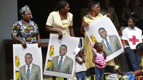 Supporters hold portraits of Emmerson Mnangagwa at his inauguration.
