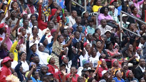 The crowd cheers and dances at the inauguration ceremony in Harare on Friday.
