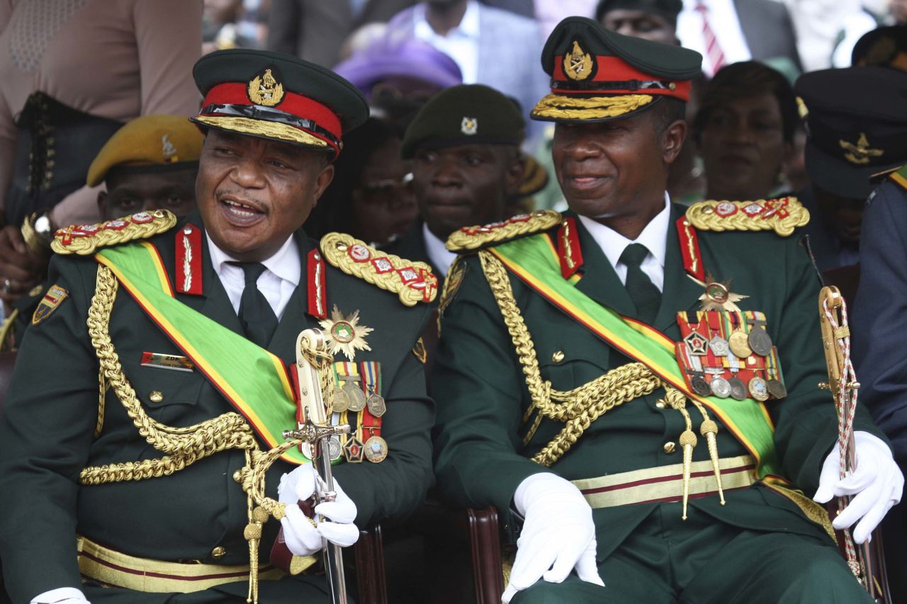 Army Gen. Constantino Chiwenga, left, talks with Lt. Gen. Valerio Sibanda during the. inauguration.