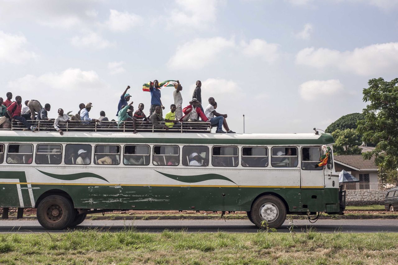 Zimbabweans make their way to the National Sports Stadium by bus.
